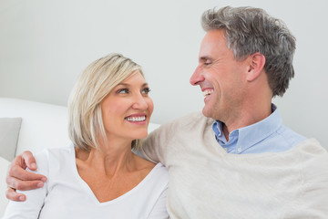 Happy couple sitting in living room