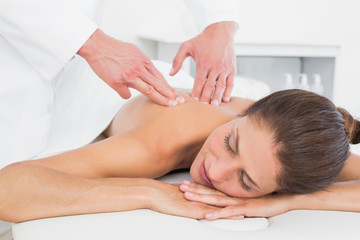 Fototapeta na wymiar Male physiotherapist massaging woman's back