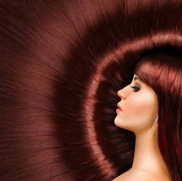 Long red shiny hair of a beautiful girl