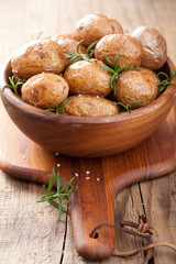 baked potatoes in wooden bowl