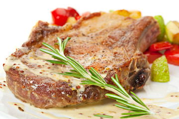 Grilled pork loin with vegetables on the plate