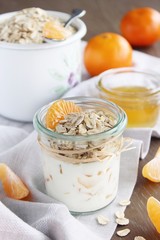 Granola  with yogurt and mandarin.