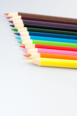 Fototapeta premium Twelve colored pencils on gray background.