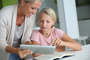 Fototapeta premium Mother helping girl with homework