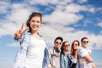 teenage girl with headphones and friends outside
