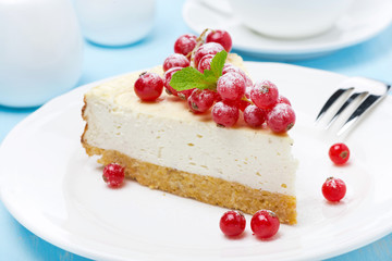 piece of cheesecake with red currant on the plate