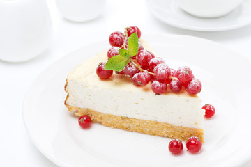 vanilla cheesecake with fresh red currants on the plate