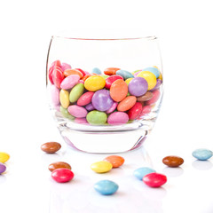 Glass of smarties, isolated on white