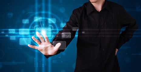 Businessman pressing high tech type of modern buttons