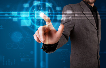 Businessman pressing high tech type of modern buttons
