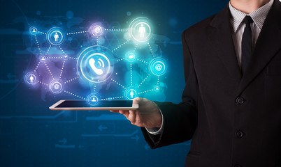 Businessman showing social networking technology with colorful l