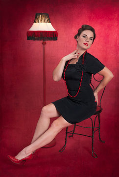 Pinup Girl in Black Dress with Lamp
