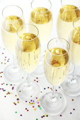 Glasses with champagne on shiny background