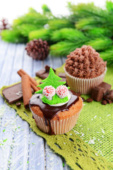 Tasty cupcake with butter cream, on color wooden background