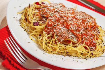 Pasta with sauce Bolognese and parmesan cheese, close-up
