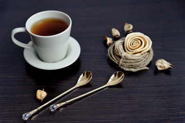Cup of tea and two stylish teaspoons
