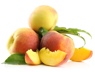 Ripe sweet peaches with leaves, isolated on white