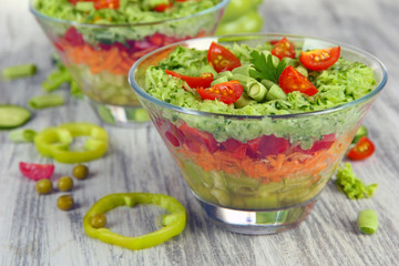 Tasty salad with fresh vegetables on wooden table