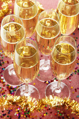 Glasses with champagne on shiny background