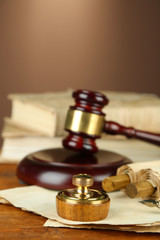 Wooden stamp, gavel and old papers on wooden table