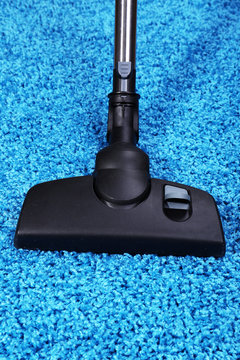 Vacuuming carpet in house