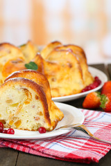 Tasty homemade cake with berries, on wooden table