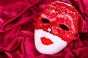 Mask on bright pink fabric background
