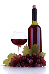 Wineglass with red wine, grape and bottle isolated on white