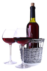 Wineglasses with red wine, and bottle isolated on white
