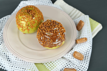 Homemade taffy apples, on napkin, on wooden background