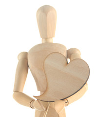 Wooden mannequin holding heart isolated on white