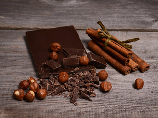 Pieces of dark chocolate on a wooden background