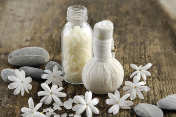 spring flower with massage ball, stones on old wood