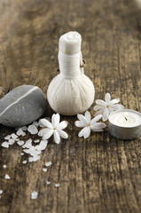 stones with massage ball ,candle on a grunge wood