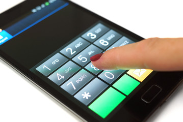 Obraz premium Woman is dialing on mobile touchscreen phone