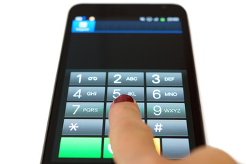 Obraz premium Woman is dialing on mobile touchscreen phone