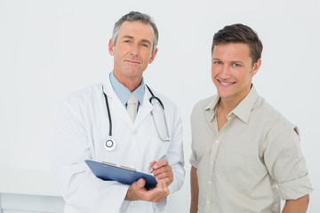 Doctor and patient with reports in medical office