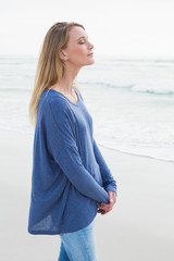 Peaceful woman with eyes closed at beach