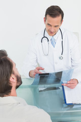 Male doctor explaining spine x-ray to patient