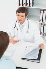 Doctor in conversation with female patient in medical office