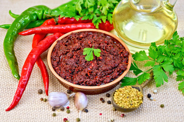 Adjika with hot pepper and oil on burlap