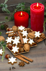 Fototapeta na wymiar cinnamon cookies, nuts and spieces with christmas decoration