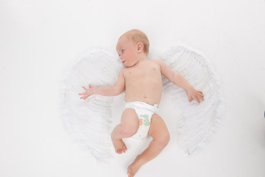 Cute little baby flying with angel wings.