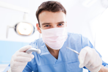 Dentist Holding Dental Tools and Wearing Face Mask