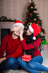 Christmas Couple.Happy Smiling Family at home celebrating