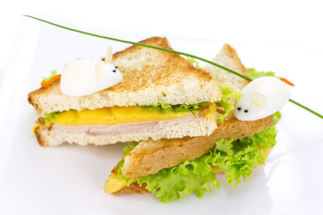 sandwich with ham and cheese, decorated eggs