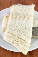 salted cod fish on white plate