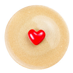 Red Heart on festive  golden  plate  isolated on white backgroun