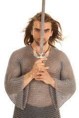 man chain mail sword front of face looking