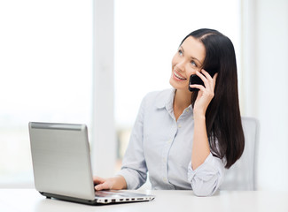 businesswoman with laptop and cell phone